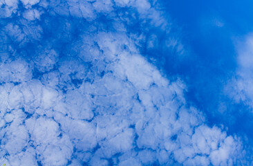 Beautiful blue sky with interesting cumulus clouds. The sky in small clouds
