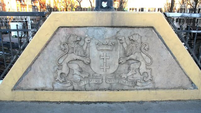 Gdansk's motto Nec Temere Nec Timide carved in a concrete part of a bridge in the city's old town part.
