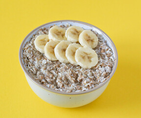 oatmeal banana porridge on yellow background
