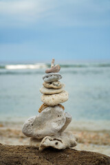 Fototapeta na wymiar An art of rocks balancing on a beach in Nusa Penida.