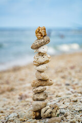 Fototapeta na wymiar An art of rocks balancing on a beach in Nusa Penida.
