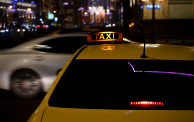 yellow taxi sign on cab car at evening or night in the city street. Moscow, Russia.