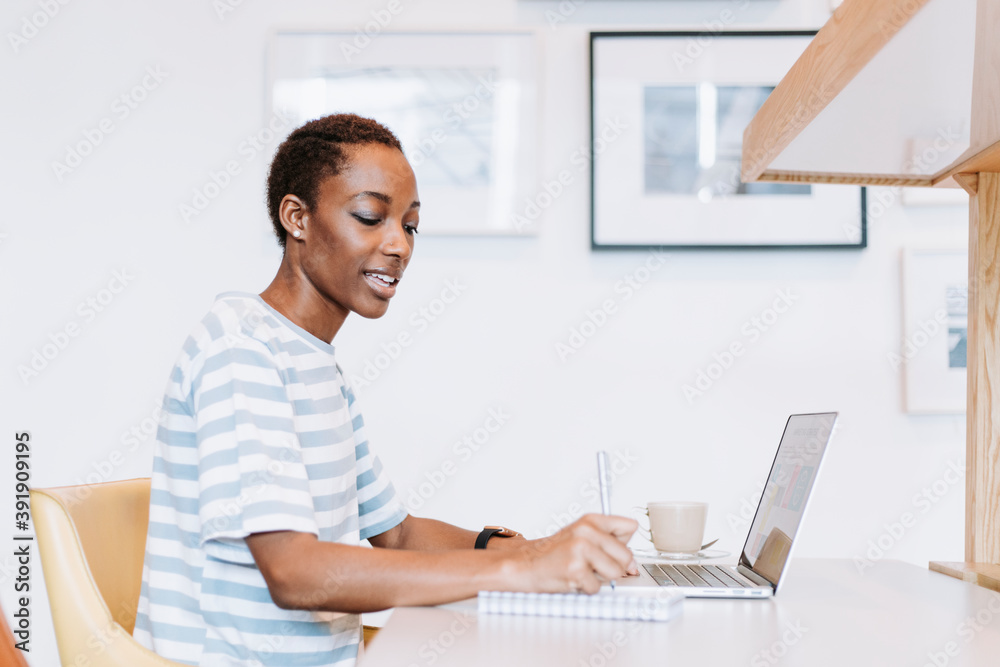 Canvas Prints Black lady taking a note in a meeting