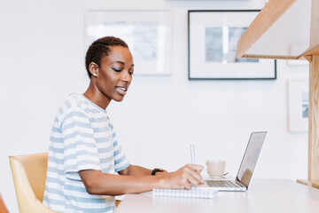 Black lady taking a note in a meeting