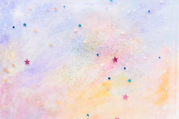 Glittery star confetti on colorful abstract pastel watercolor background