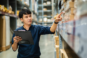 man worker holding clipboard and checking inventory in the warehouse store