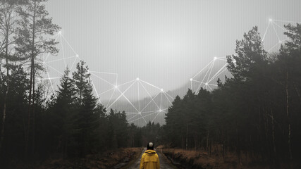 Rear view of a woman in a yellow windbreaker standing in a misty forest © Rawpixel.com