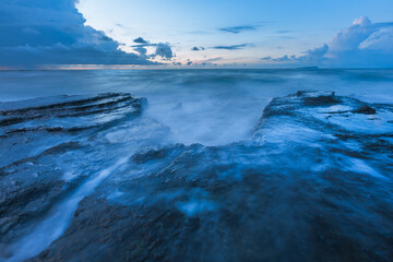 Closeup of rocks on the coast at sunrise, beautiful coastal landscape