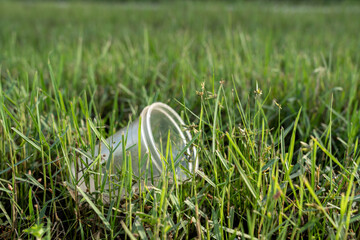 Discarded plastic cup in grass