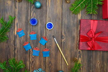 new year's creativity, preparation for Christmas, drawing with a brush and acrylic paints wooden decorat home on the table top view