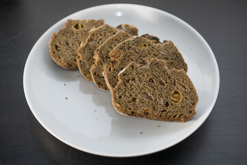Pumpernickel bread on white plate