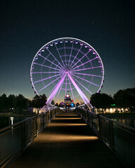 Montreal great wheel at sunrise with a sky full of stars
