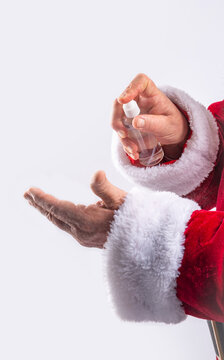 Santa Claus cleaning hands with gel, preventing covid in white background
