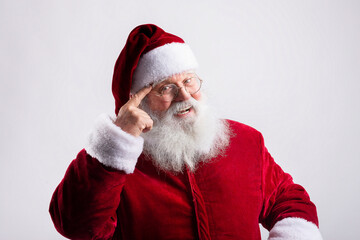 Happy smart Santa Claus, pointing  his head in white background
