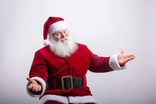 Happy Santa Claus, sat with arms open in white background