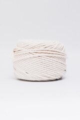 Cotton ropes are material for macrame weaving. Over the white background surface. Flat lay, top view. Step by step instructions for macrame weaving.