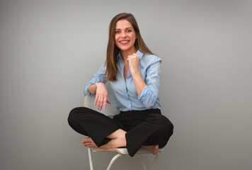 young woman sitting on chair with crossed legs