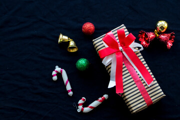 gift box for special in christmas and happy new year festival with decorate small bell arrangment flat lay postcard style on background black