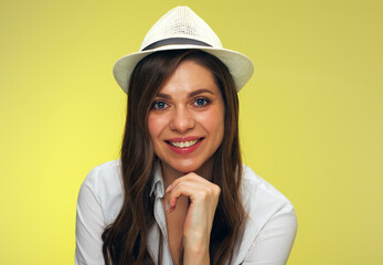 face portrait of smiling woman in white shirt wearing hat.