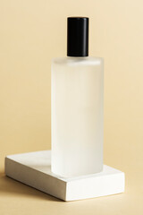 Blank perfume glass bottle on a white stone