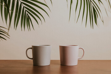 Earth tone color ceramic coffee cups on wooden table