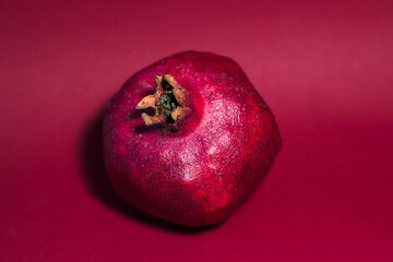 fresh pomegranate on a red background