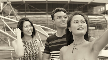 Asian friends outdoor having fun visiting city