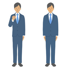青いスーツを着た男性　ガッツポーズ、直立