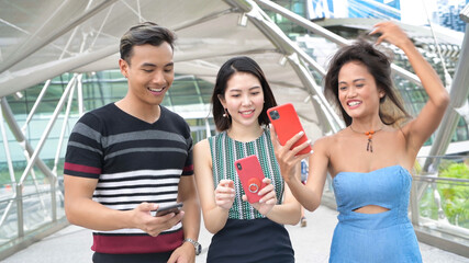 Three asian young friends enjoy outdoor time visiting a new city