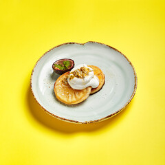 Pineapple slices with maracuya sauce side view