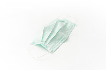 Surgical mask with rubber ear straps isolated on white. White mask to cover the mouth and nose. Procedure mask from bacteria.