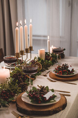 Christmas table setting with decorations and candles
