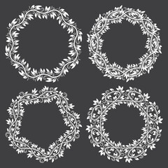 Patterned round frames for design in floral vintage style. White ornaments on black background.