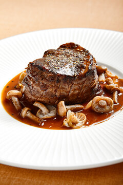 Filet mignon served with mushrooms side view