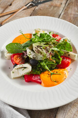 Roasted pepper salad with calamari and fresh greens