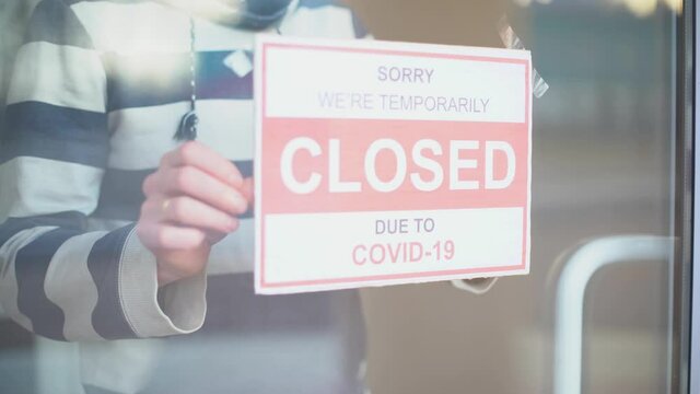 Closed for business due to covid. Small shop puts closed sign up on storefront