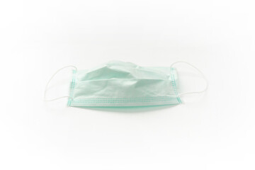 Surgical mask with rubber ear straps isolated on white background. White mask to cover the mouth and nose.