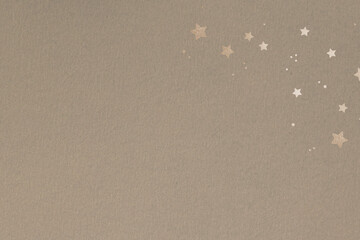 Shimmering gold stars on a beige background