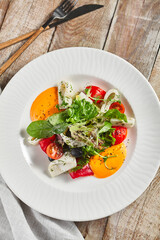 Roasted pepper salad with calamari and fresh greens