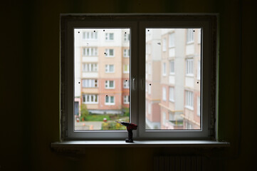 Photo of the installation of a double-leaf window in a city apartment