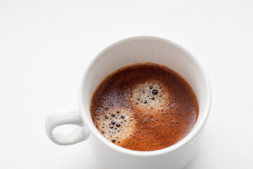 Cup of freshly brewed coffee on white background