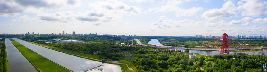 Fototapeta premium Panoramic view of Moscow on a sunny day, Russia. Picturesque region in the north-west of Moscow city. Zhivopisny bridge across the Moscow river.