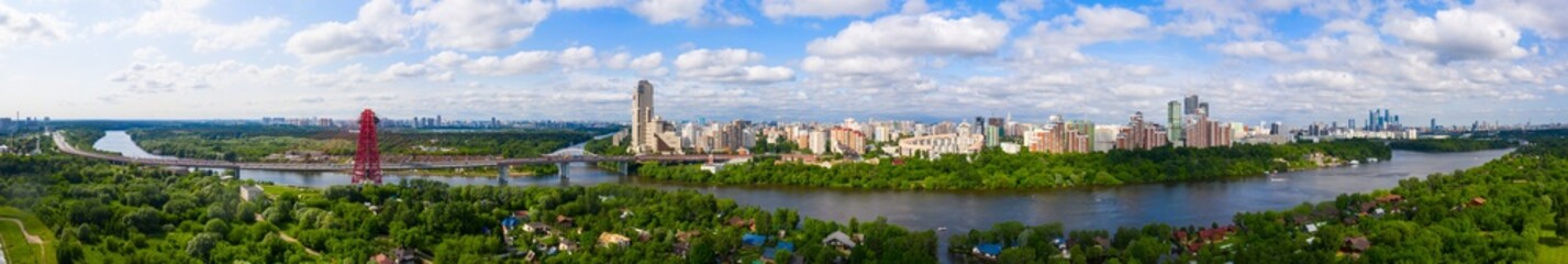Fototapeta na wymiar Panoramic view of Moscow on a sunny day, Russia. Picturesque region in the north-west of Moscow city. Zhivopisny bridge across the Moscow river.