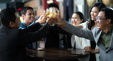 Group of friends Hands Hold Beverage Beers Bottle and toasting in the club. Celebration, Party People Christmas and Happy new year concept. Asian business people in party.