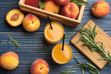 Natural peach juice and fresh fruits on blue wooden table, flat lay