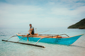 Guy on a fishing boat in the Philippines around the ocean
