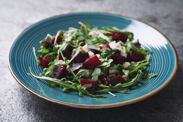 Fresh delicious beet salad on grey table, closeup