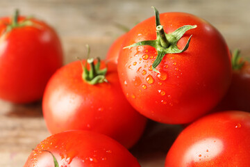 Fresh ripe tomatoes on wooden table, closeup