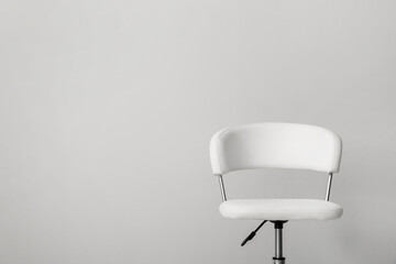 Comfortable office chair on light background. Space for text