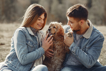 Woman in a jeans clothes. Couple in a spring forest. People with a cute dog.